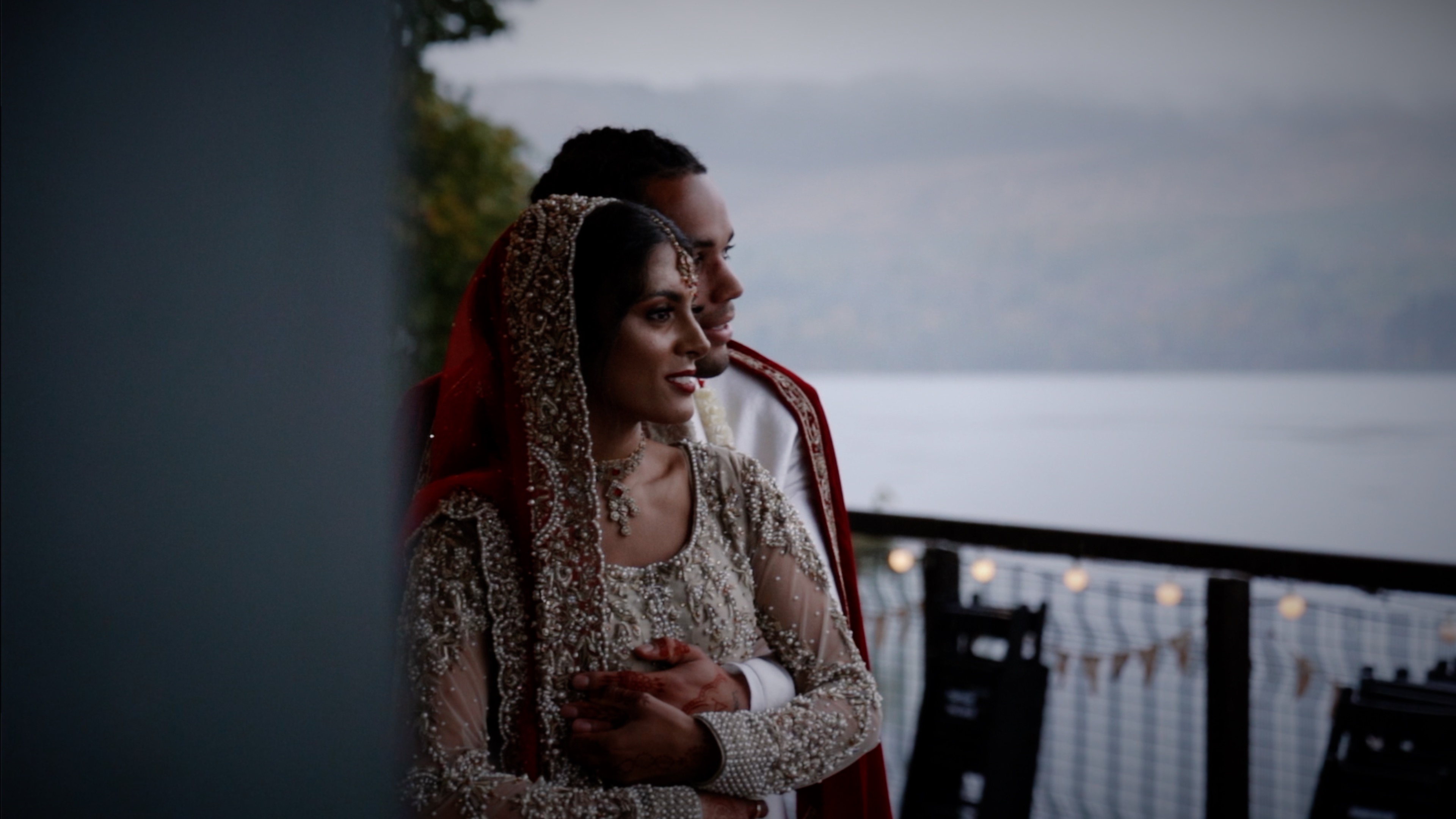 Amna and Joshua, husband and wife standing by the loch in Scotland